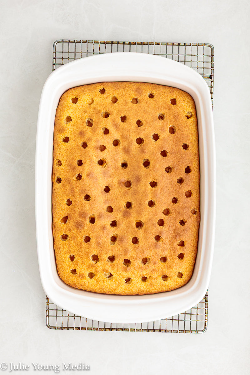 Strawberry Poke Cake with Whipped Vanilla Cream Cheese Frosting